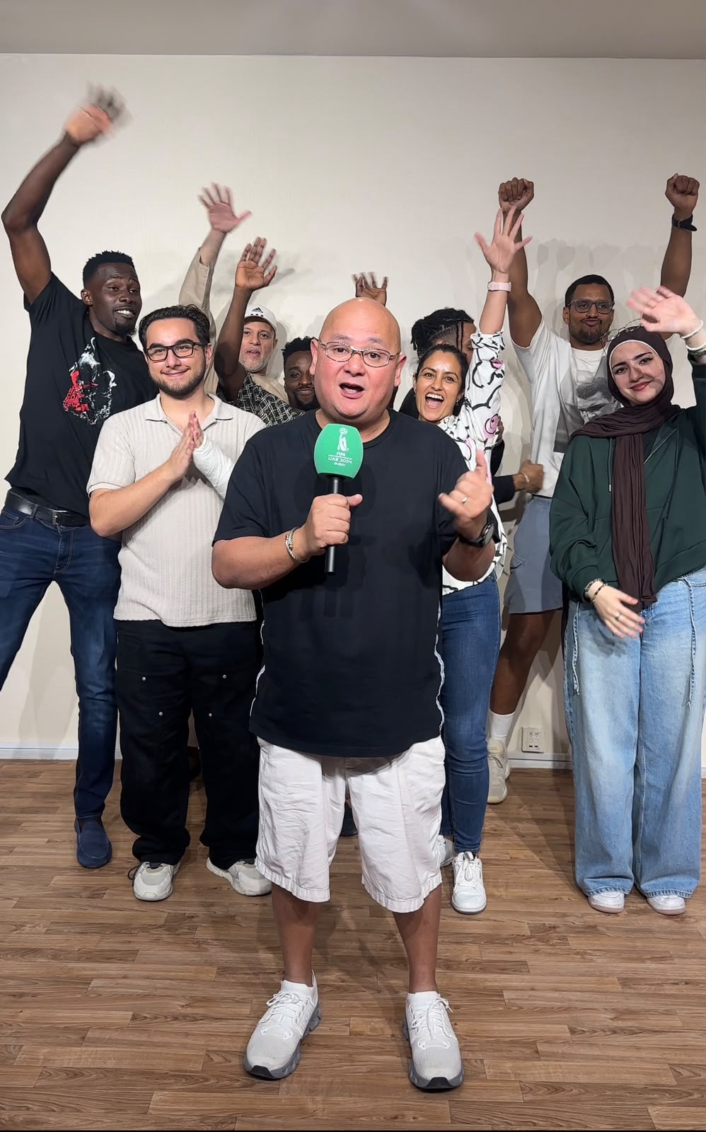 Man speaking with the On The Mic team behind him